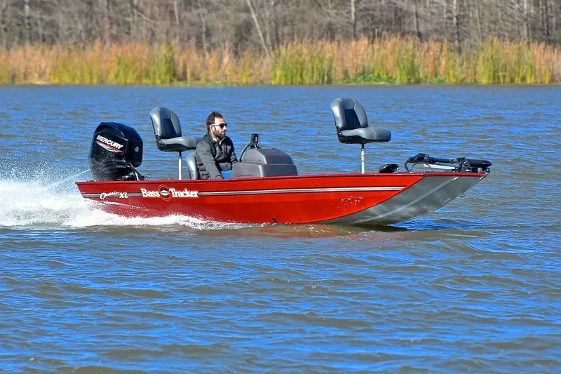 The Image of 2023 Bass Tracker Classic boat cruising on a lake with a Mercury engine. - 1