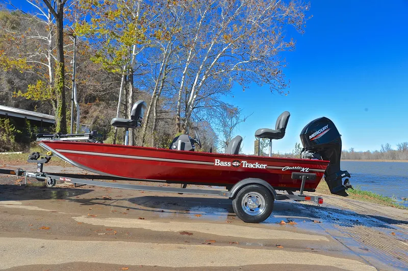 Slide: The Image of 2023 Bass Tracker Classic boat on trailer by a scenic lake. - 11
