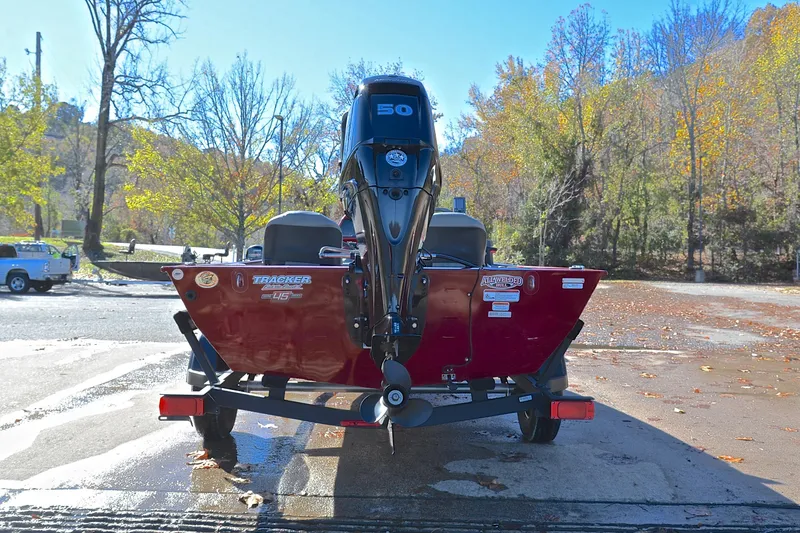 Slide: The Image of 2023 Bass Tracker Classic boat on trailer, parked in scenic autumn setting. - 13