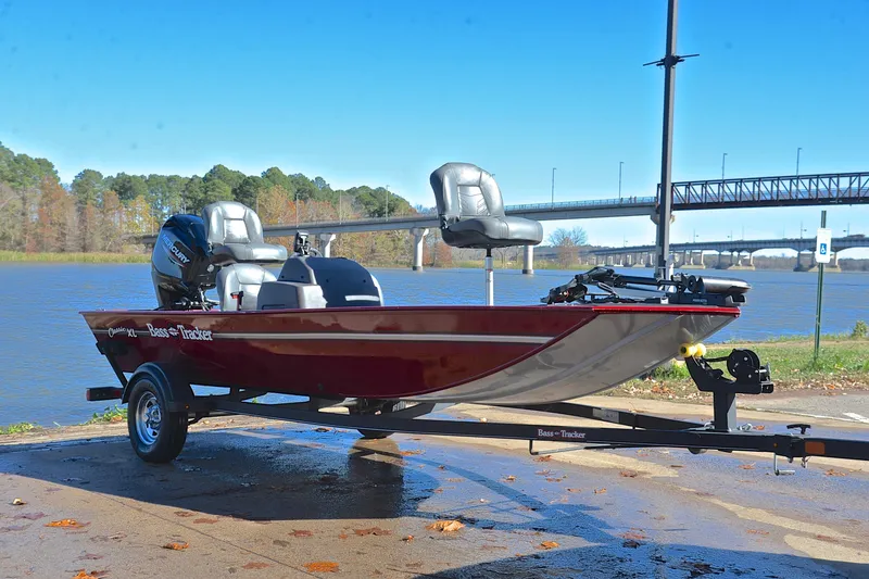 Slide: The Image of 2023 Bass Tracker Classic boat on trailer by a scenic river. - 16
