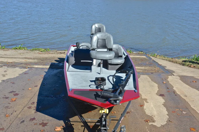 Slide: The Image of 2023 Bass Tracker Classic boat on a ramp by the water. - 17