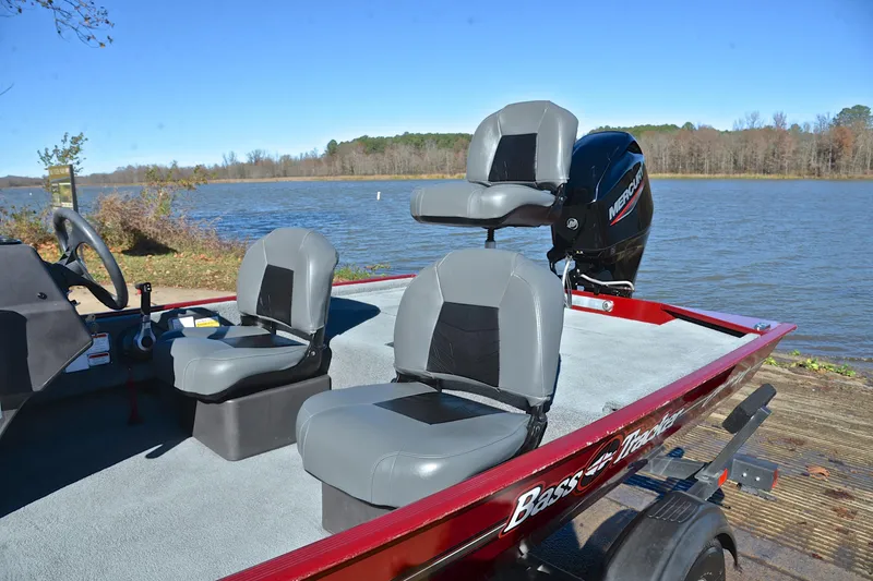 Slide: The Image of 2023 Bass Tracker Classic boat with gray seats by a serene lake. - 18