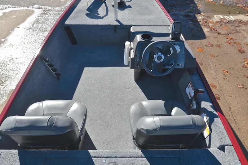 Slide: The Image of 2023 Bass Tracker Classic boat interior with steering wheel and seats. - 20