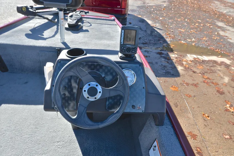 Slide: The Image of 2023 Bass Tracker Classic boat dashboard with steering wheel and fish finder. - 23
