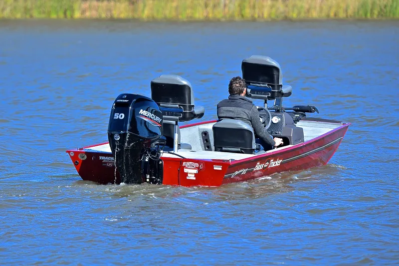 Slide: The Image of 2023 Bass Tracker Classic boat on water, featuring Mercury 50 engine. - 8