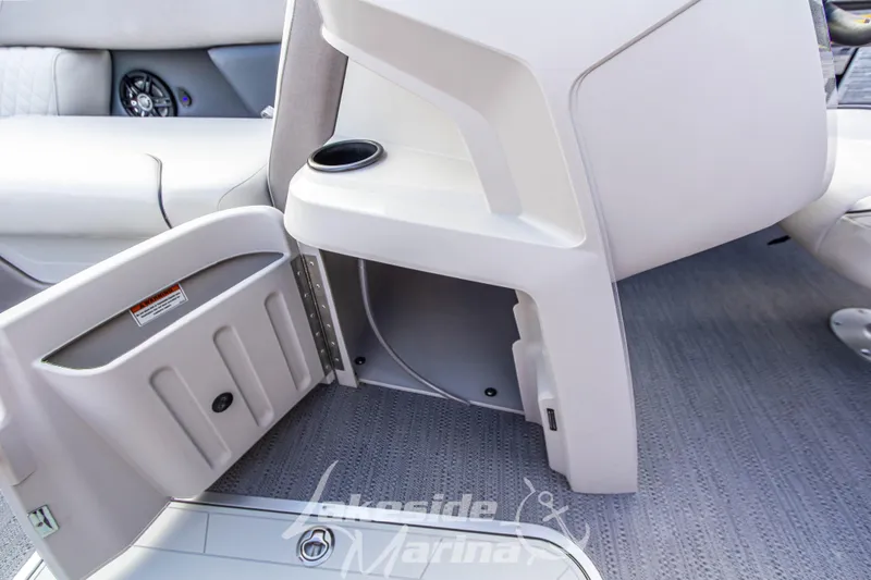 Slide: The Image of 2025 Godfrey Sweetwater 2286 SFL boat interior storage compartment with cup holder. - 18