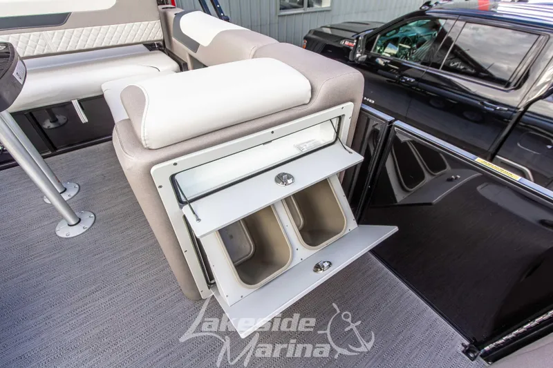 Slide: The Image of 2025 Godfrey Sweetwater 2286 SFL boat interior with storage compartment open, showcasing seating and flooring. - 20
