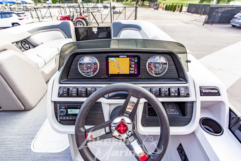 Slide: The Image of 2025 Godfrey Sweetwater 2286 SFL boat dashboard with navigation display and controls. - 22