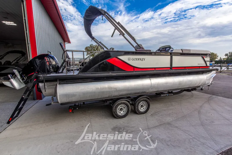 Slide: The Image of 2025 Godfrey Sweetwater 2286 SFL pontoon boat on trailer at Lakeside Marina. - 3