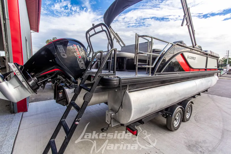 Slide: The Image of 2025 Godfrey Sweetwater 2286 SFL pontoon boat with powerful outboard motor at marina. - 4