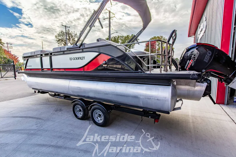 Slide: The Image of 2025 Godfrey Sweetwater 2286 SFL pontoon boat on trailer at Lakeside Marina. - 7