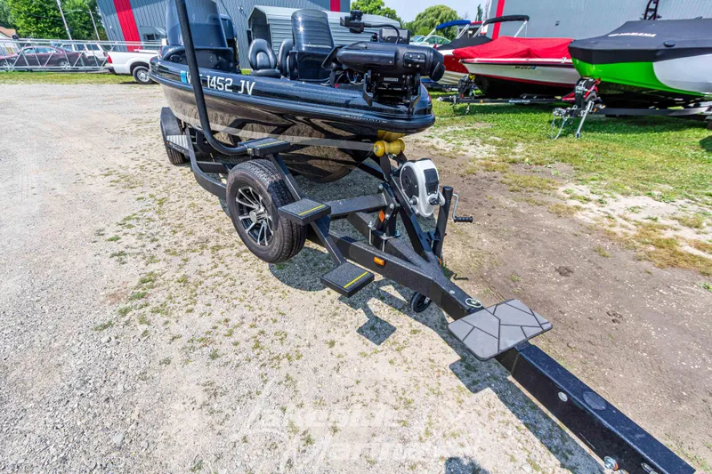 Slide: The Image of 2025 Recon 2185 DC boat on trailer, parked outdoors. - 10