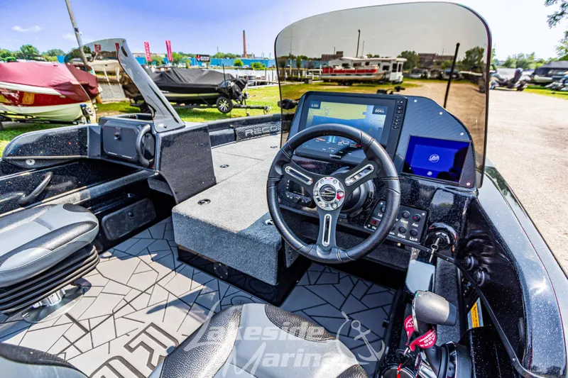Slide: The Image of 2025 Recon 2185 DC boat interior with modern dashboard and steering wheel. - 16