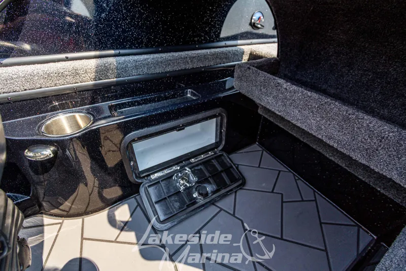 Slide: The Image of 2025 Recon 2185 DC boat interior with storage compartment and cup holder. - 25