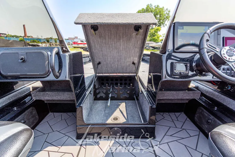 Slide: The Image of Recon 2185 DC 2025 boat interior with open storage compartment and modern dashboard. - 26