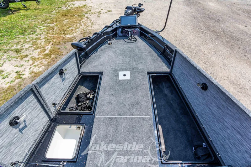 Slide: The Image of 2025 Recon 2185 DC boat interior with storage compartments and fishing equipment. - 29