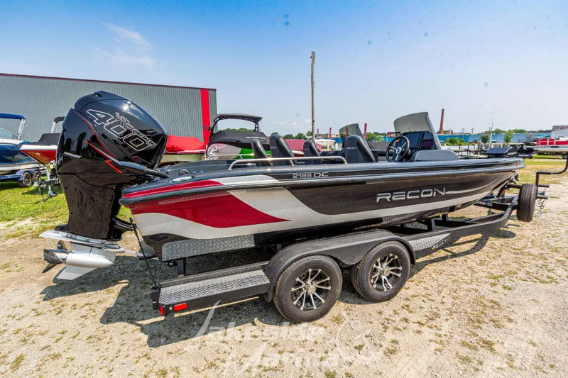 Slide: The Image of 2025 Recon 2185 DC boat with powerful engine, parked outdoors on a sunny day. - 3