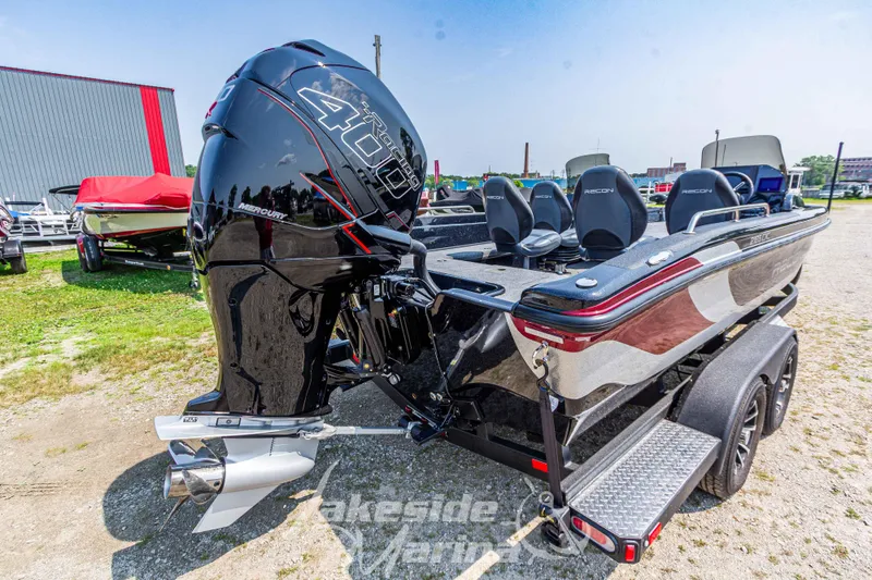 Slide: The Image of 2025 Recon 2185 DC boat with powerful outboard motor, parked on a trailer. - 4