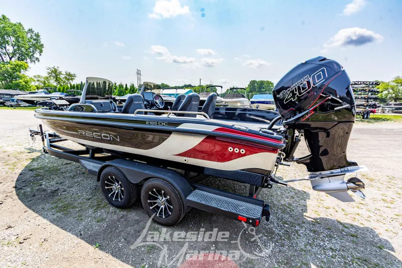 Slide: The Image of 2025 Recon 2185 DC boat on trailer with powerful outboard motor, displayed outdoors. - 7