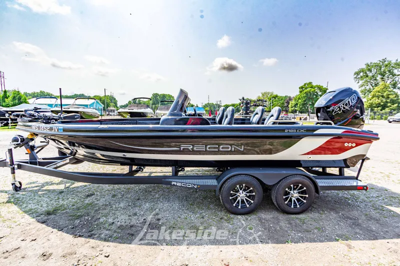 Slide: The Image of 2025 Recon 2185 DC boat on trailer, outdoors, sunny day. - 8