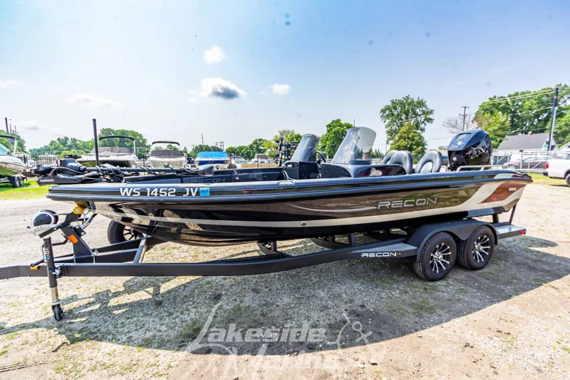Slide: The Image of 2025 Recon 2185 DC boat on trailer, parked outdoors. - 9