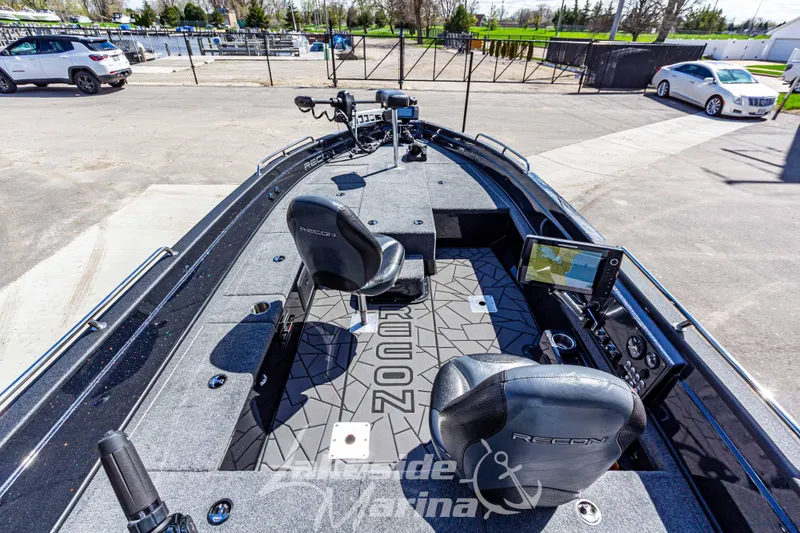Slide: The Image of 2025 Recon 895 Tiller boat interior with advanced navigation system and comfortable seating. - 12