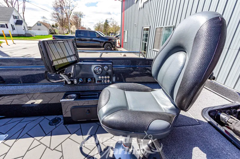 Slide: The Image of 2025 Recon 895 Tiller boat interior with control panel and cushioned seat. - 15