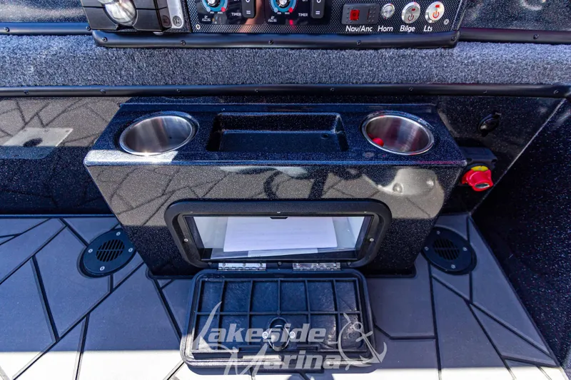 Slide: The Image of Control panel of 2025 Recon 895 Tiller boat with cup holders and storage compartment. - 19