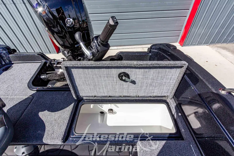 Slide: The Image of 2025 Recon 895 Tiller boat with open storage compartment at Lakeside Marina. - 21
