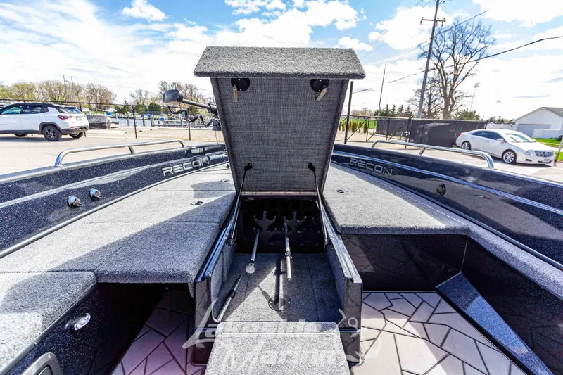 Slide: The Image of 2025 Recon 895 Tiller boat with open storage compartment, showcasing sleek design and functionality. - 26