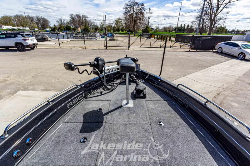 Slide: The Image of 2025 Recon 895 Tiller boat at Lakeside Marina, featuring advanced navigation equipment. - 27