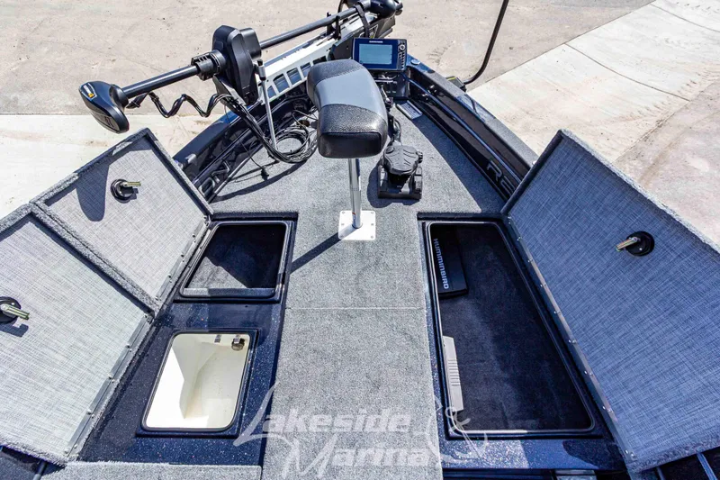 Slide: The Image of 2025 Recon 895 Tiller boat interior with storage compartments and fishing equipment. - 28
