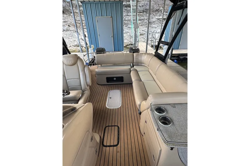 Slide: The Image of 2016 Harris Grand Mariner SL 250 Twin Engine boat interior with beige seating and wood flooring. - 10