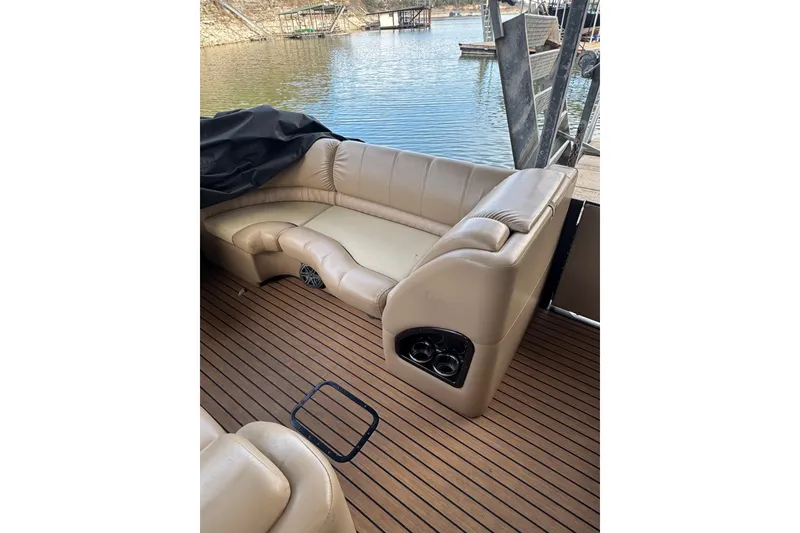 Slide: The Image of 2016 Harris Grand Mariner SL 250 boat interior with beige seating and wood flooring. - 6