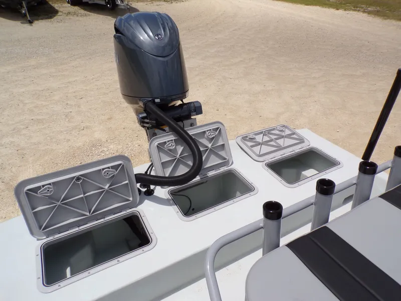 Slide: The Image of 2026 Shoalwater 20' Catamaran with open storage compartments and outboard motor. - 27