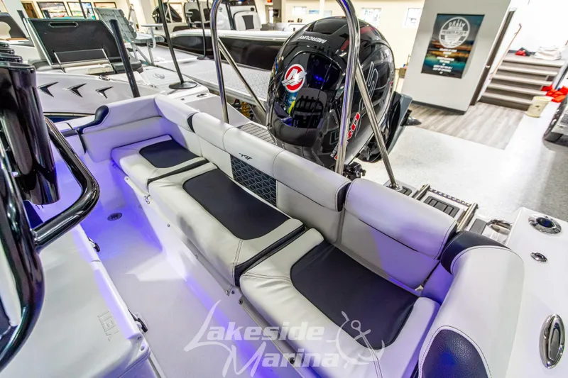 Slide: The Image of 2025 Tidewater 210 LXF boat interior with seating and Mercury engine at Lakeside Marina. - 12