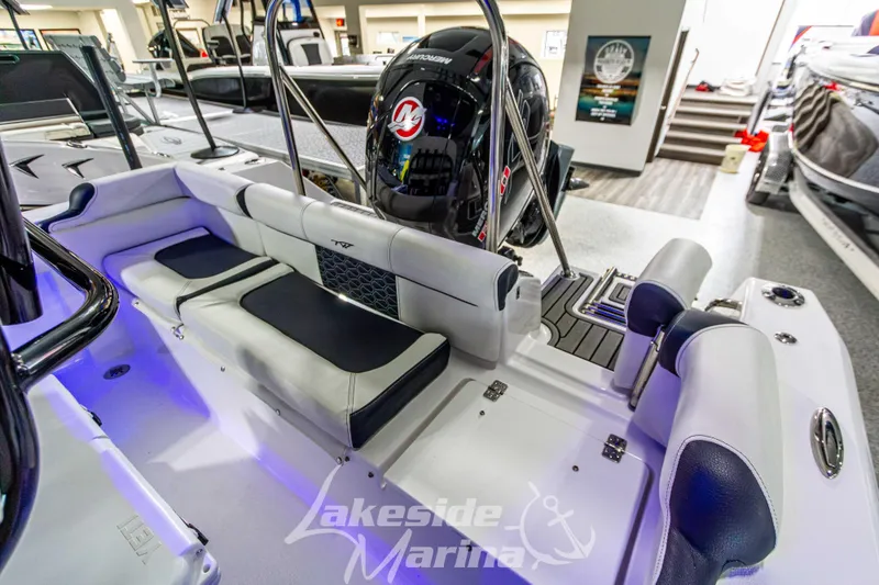 Slide: The Image of 2025 Tidewater 210 LXF boat interior with seating and Mercury engine at Lakeside Marina. - 13
