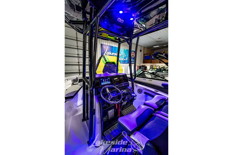 Slide: The Image of Interior view of 2025 Tidewater 210 LXF boat with illuminated dashboard and seating. - 21