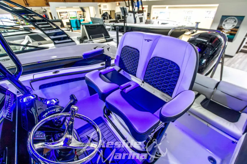 Slide: The Image of 2025 Tidewater 210 LXF boat interior with modern seating and steering wheel at Lakeside Marina. - 22