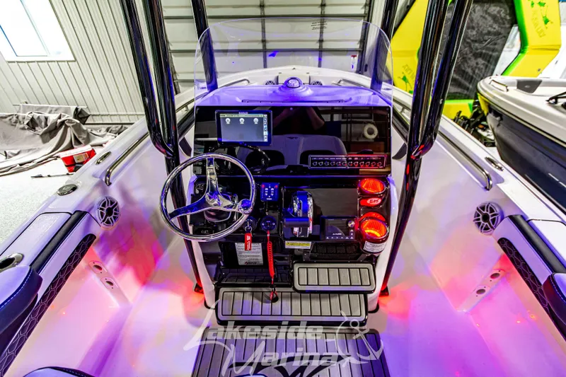 Slide: The Image of 2025 Tidewater 210 LXF boat dashboard with illuminated controls and steering wheel. - 26