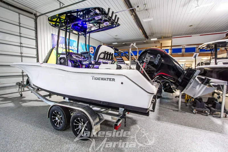 Slide: The Image of 2025 Tidewater 210 LXF boat on trailer in showroom, featuring sleek design and powerful engine. - 3