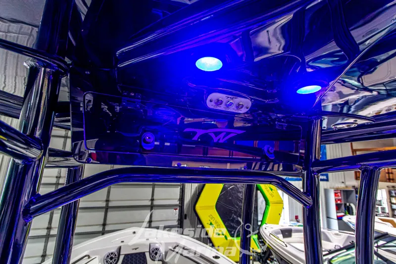 Slide: The Image of 2025 Tidewater 210 LXF boat interior with blue LED lighting and sleek design. - 30