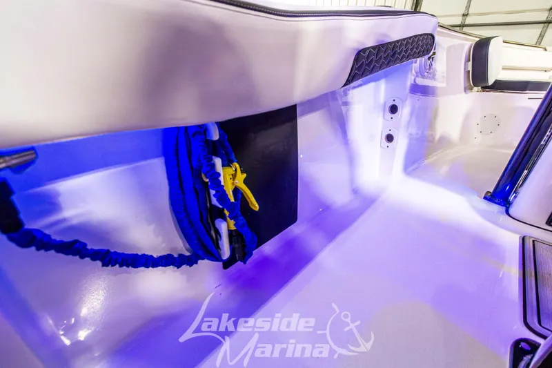 Slide: The Image of 2025 Tidewater 210 LXF boat interior with blue lighting and storage area. - 31
