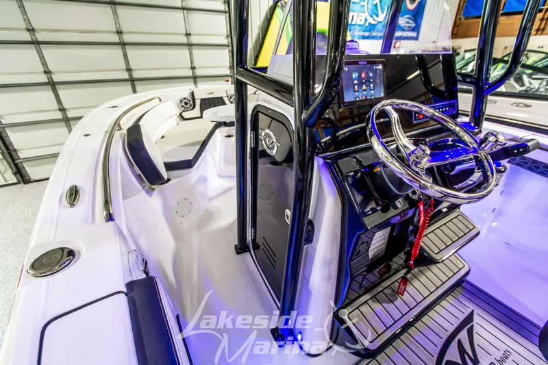 Slide: The Image of 2025 Tidewater 210 LXF boat interior with modern steering and control panel. - 34