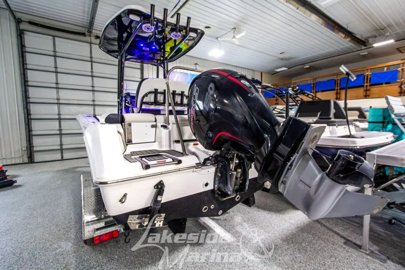 Slide: The Image of 2025 Tidewater 210 LXF boat with powerful outboard motor in a showroom. - 4