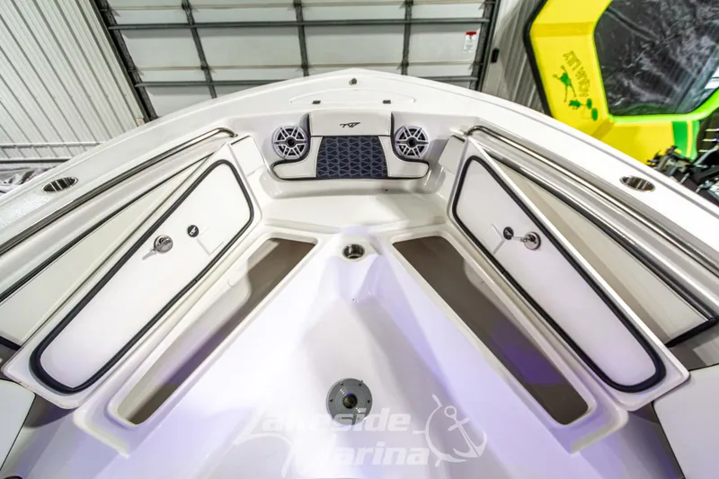 Slide: The Image of 2025 Tidewater 210 LXF boat interior with storage compartments and speakers. - 44