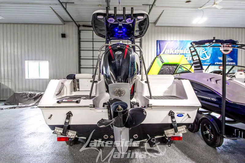 Slide: The Image of 2025 Tidewater 210 LXF boat in showroom, rear view with outboard motor. - 5