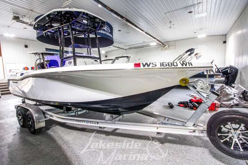 Slide: The Image of 2025 Tidewater 210 LXF boat on trailer in indoor showroom. - 7