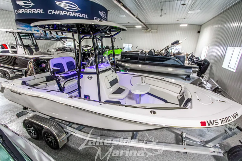 Slide: The Image of 2025 Tidewater 210 LXF boat displayed indoors at Lakeside Marina. - 8