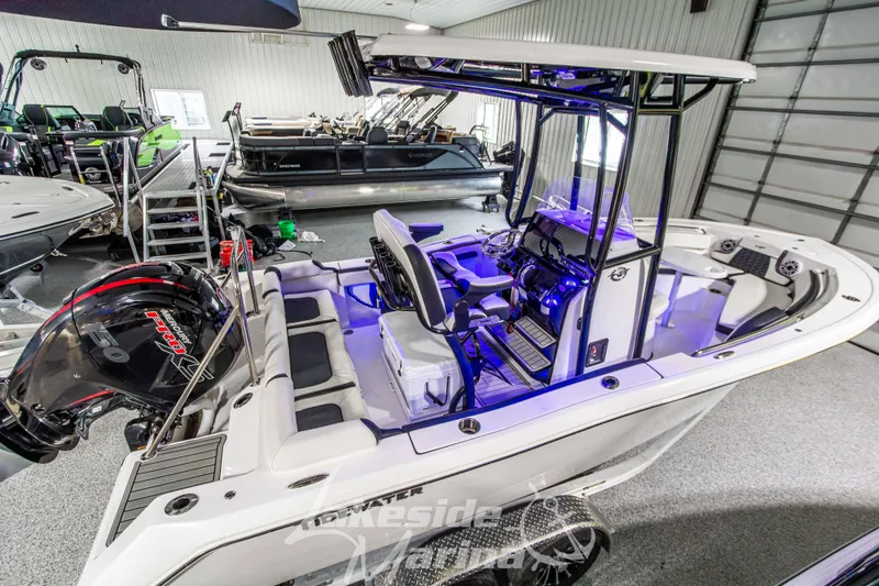 Slide: The Image of 2025 Tidewater 210 LXF boat in showroom, featuring modern design and advanced controls. - 9